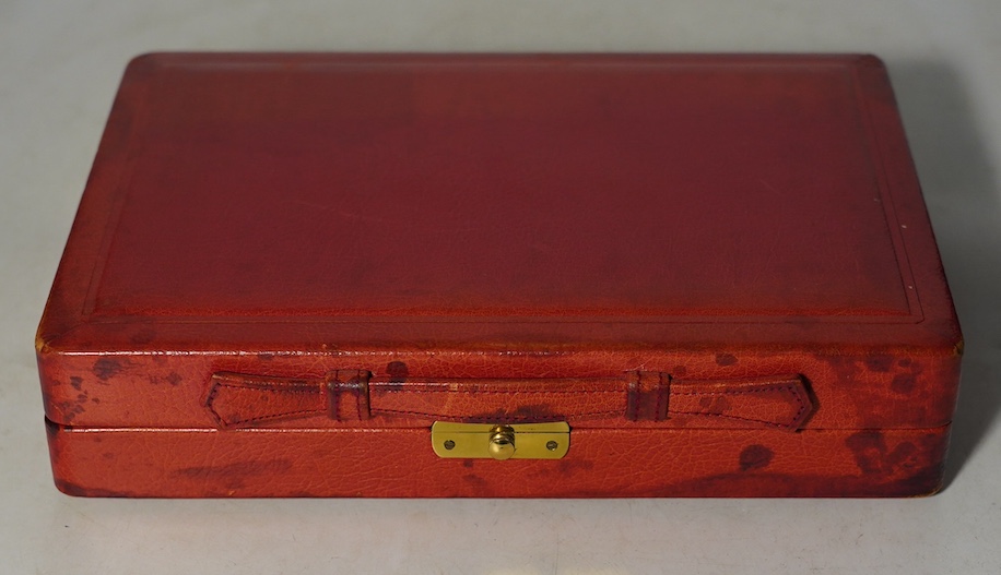 A Geoffrey Parker red leather backgammon set and a black leatherette wrist watch case